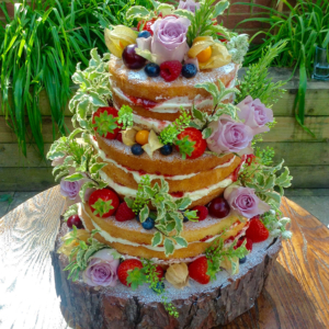 Three tiered summer fruit and flowers naked wedding cake