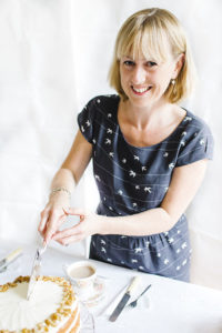 Lucy Lovell cutting a cake